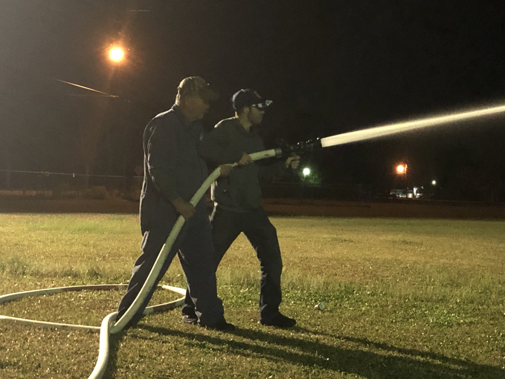 Captain Gerald Andras, Sr. teaches Junior Firefighter Seth Delatte how to handle a pressurized line during training.Picture